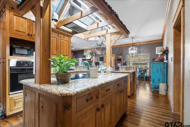 a kitchen with stainless steel appliances granite countertop a sink and cabinets