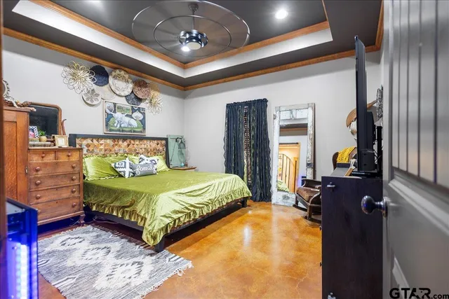 a bedroom with a bed and a chandelier