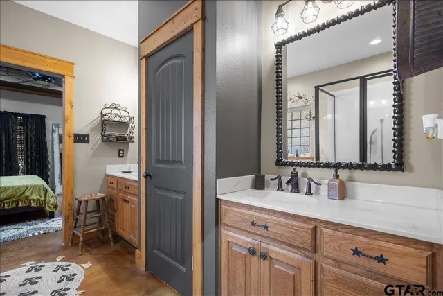 a en suite bathroom with a sink double vanity and a mirror