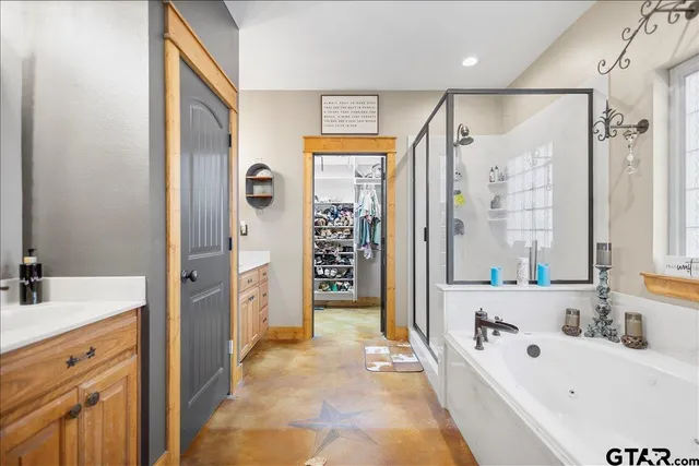 a bathroom with a tub sink and mirror