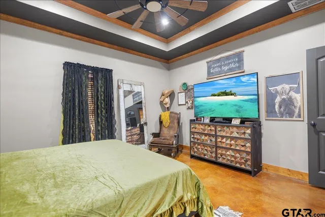 a bedroom with bed and flat screen tv