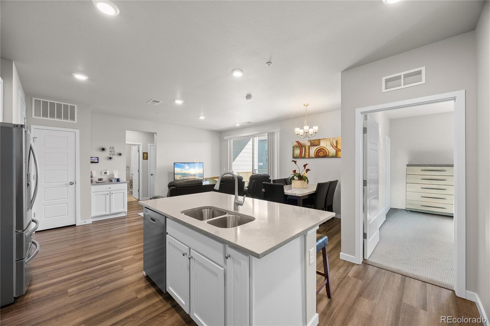 a kitchen with a refrigerator a sink and cabinets