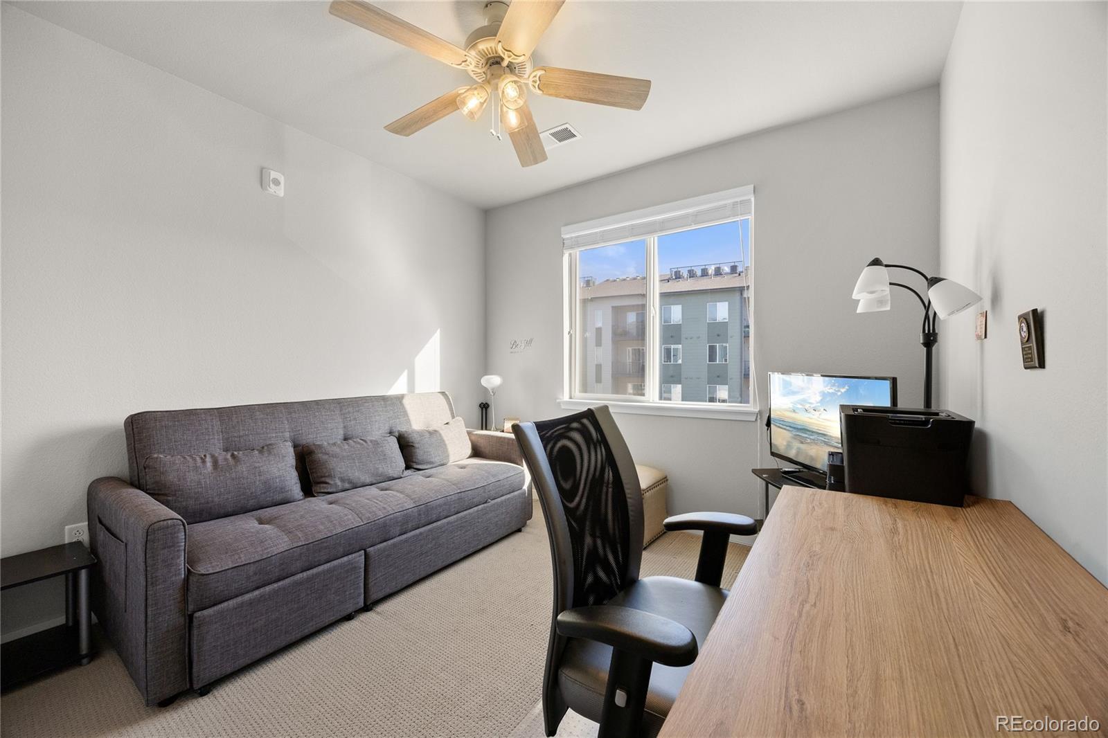9291 Twenty Mile Road, Unit 303 Parker, CO 80134 - Photo 12 of 28 a living room with furniture and a window