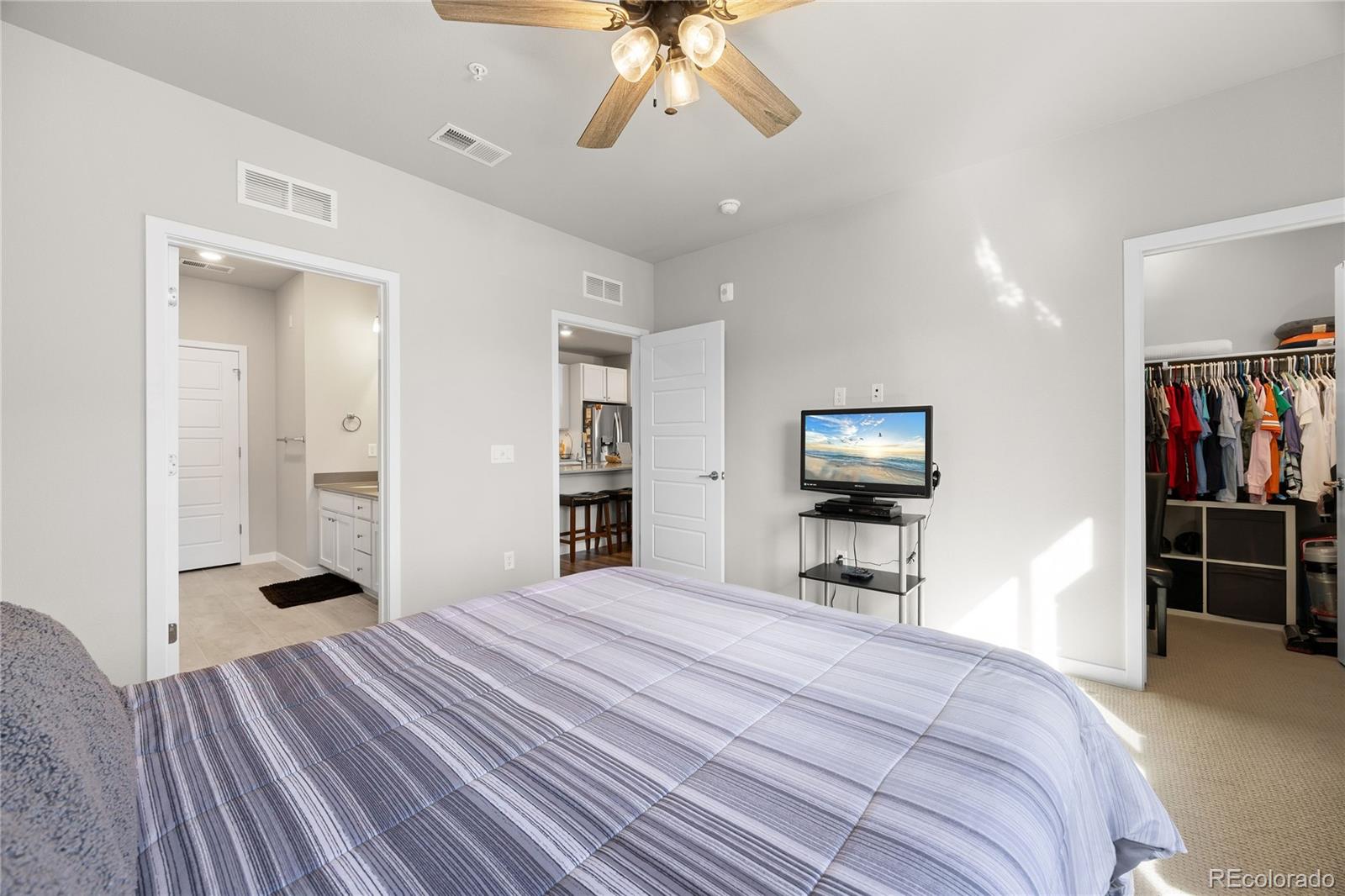 9291 Twenty Mile Road, Unit 303 Parker, CO 80134 - Photo 15 of 28 a bedroom with a bed and a view of kitchen