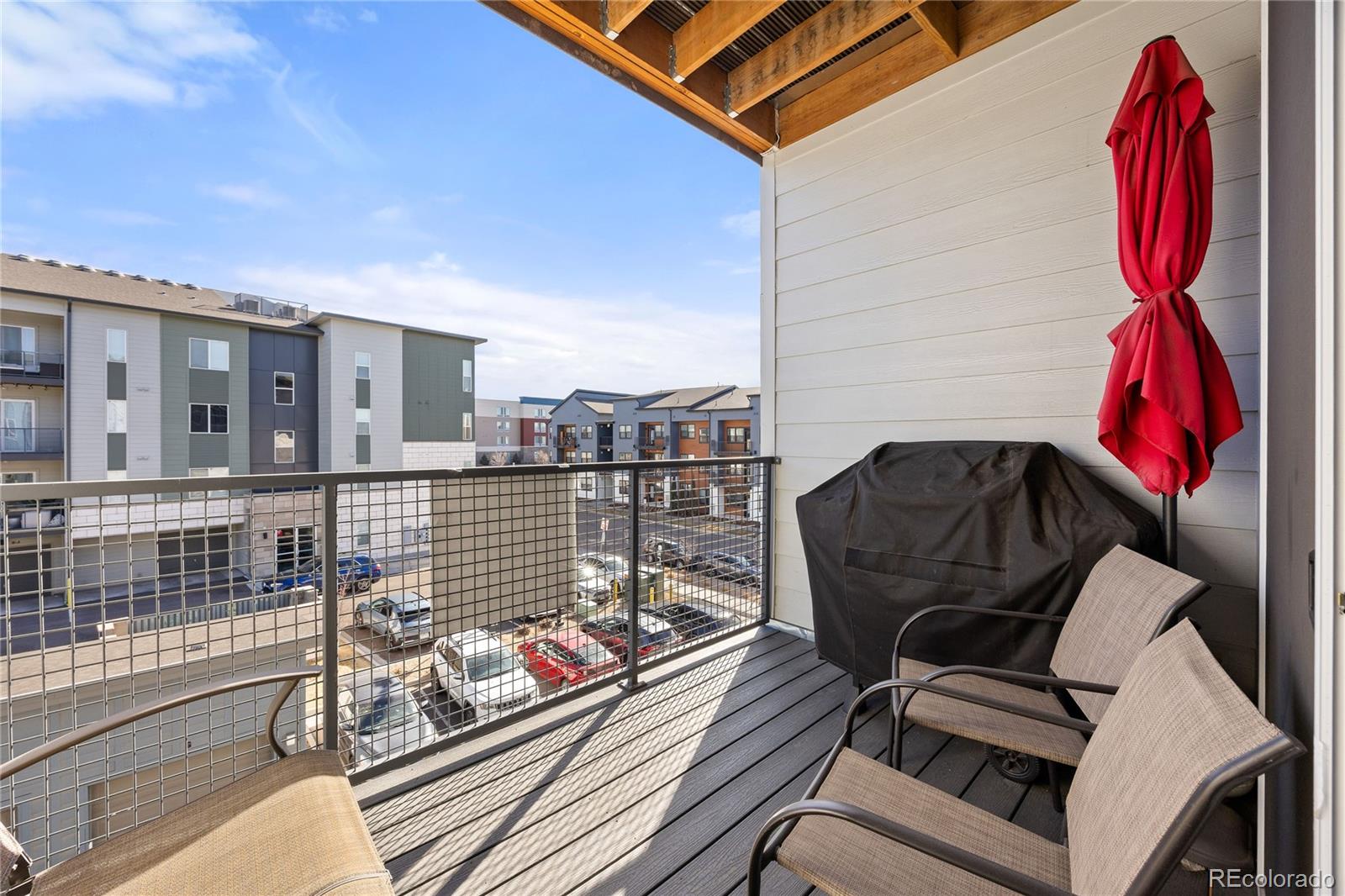 9291 Twenty Mile Road, Unit 303 Parker, CO 80134 - Photo 21 of 28 a view of a balcony with chair and wooden floor