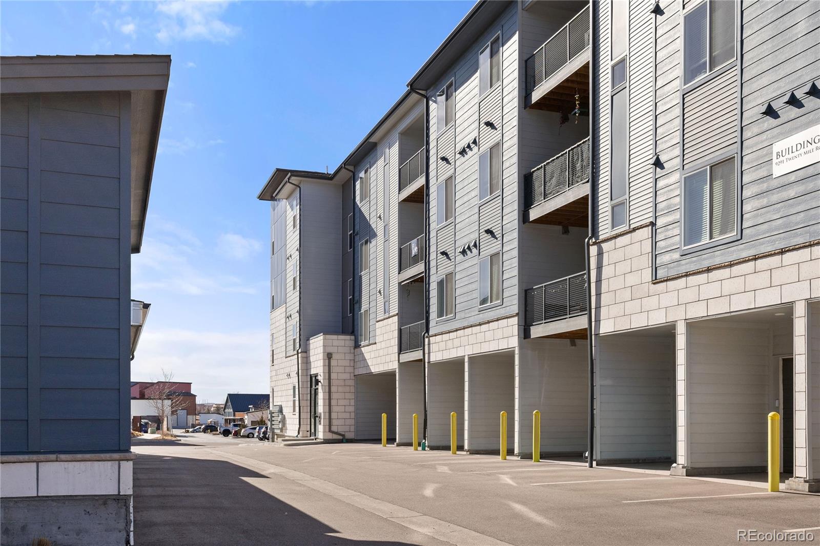 9291 Twenty Mile Road, Unit 303 Parker, CO 80134 - Photo 24 of 28 a city street with tall building