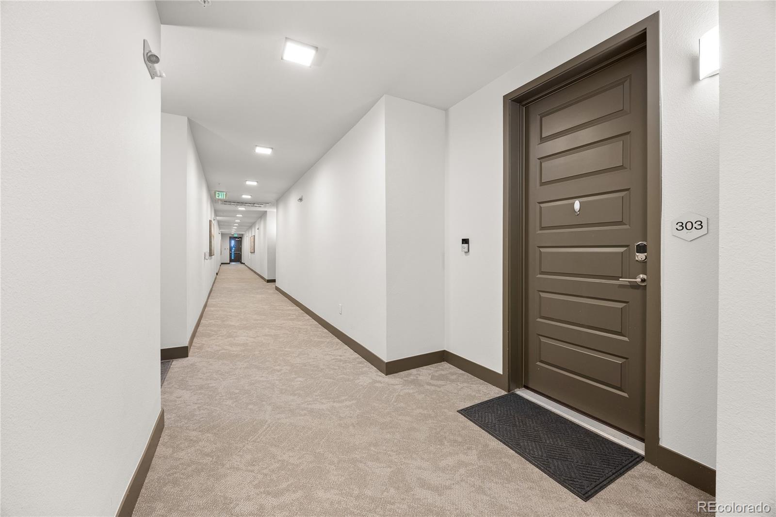 9291 Twenty Mile Road, Unit 303 Parker, CO 80134 - Photo 3 of 28 a view of a hallway with closet