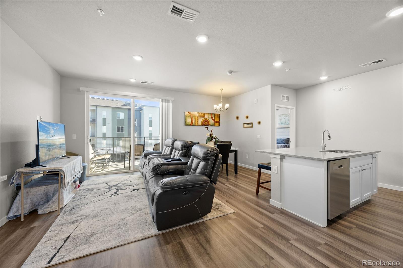 9291 Twenty Mile Road, Unit 303 Parker, CO 80134 - Photo 4 of 28 a living room with furniture and a flat screen tv