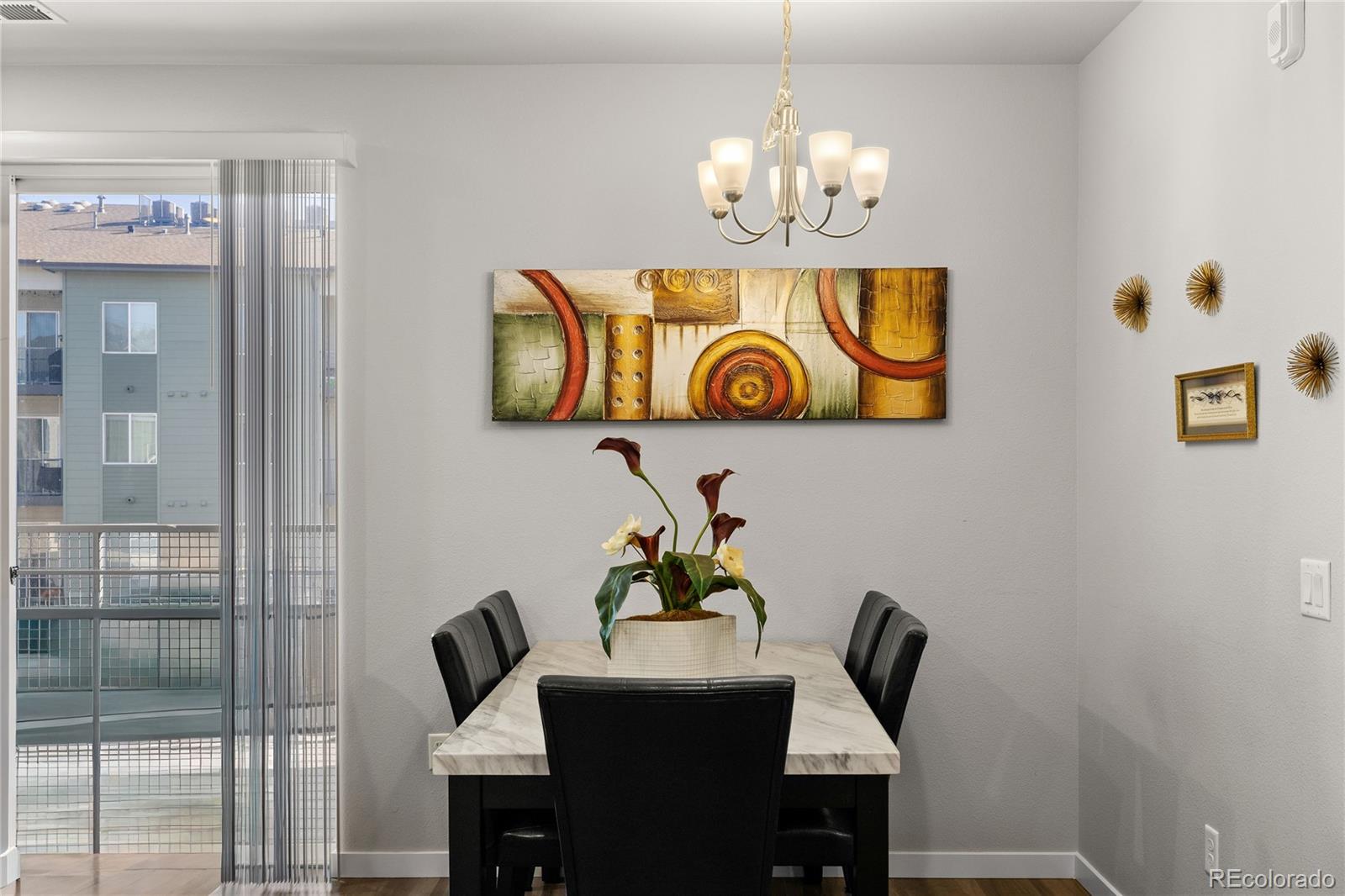 9291 Twenty Mile Road, Unit 303 Parker, CO 80134 - Photo 8 of 28 a table with a vase and flowers on it