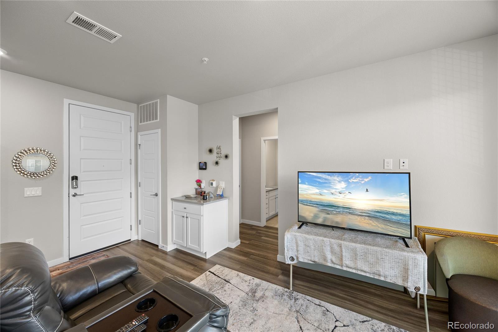 9291 Twenty Mile Road, Unit 303 Parker, CO 80134 - Photo 9 of 28 a living room with furniture and a flat screen tv