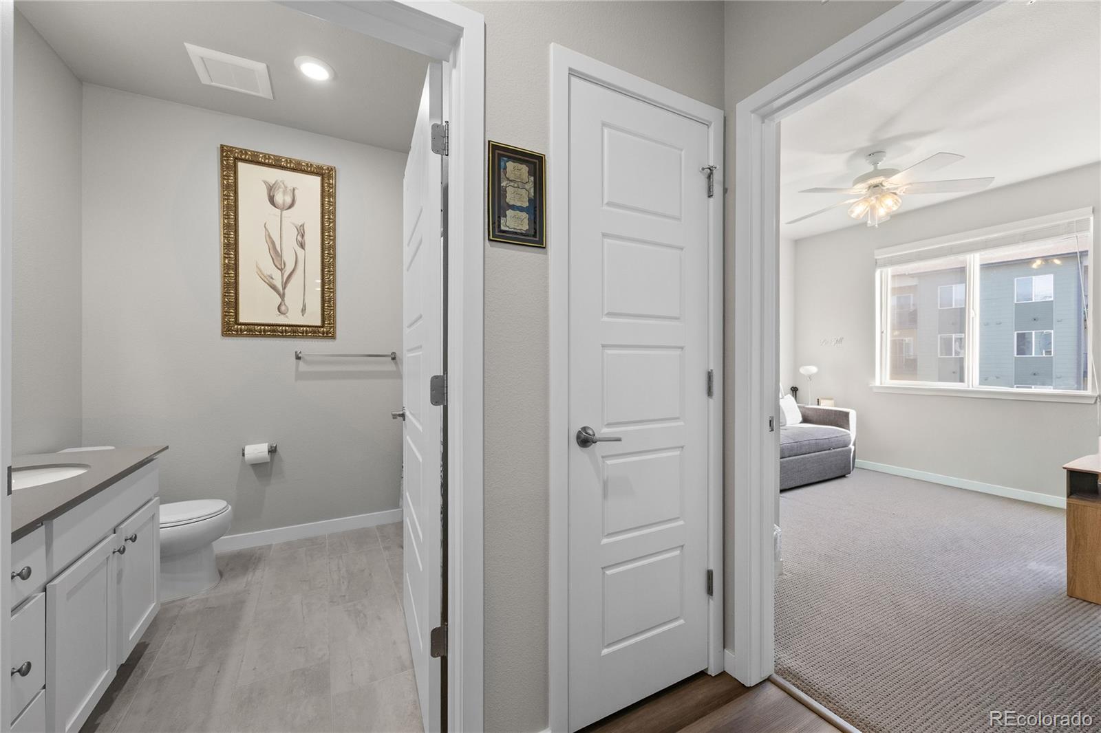 9291 Twenty Mile Road, Unit 303 Parker, CO 80134 - Photo 10 of 28 a bathroom with a toilet sink and a mirror