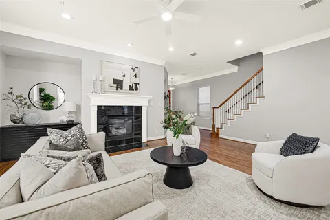 a living room with furniture a table and a fireplace