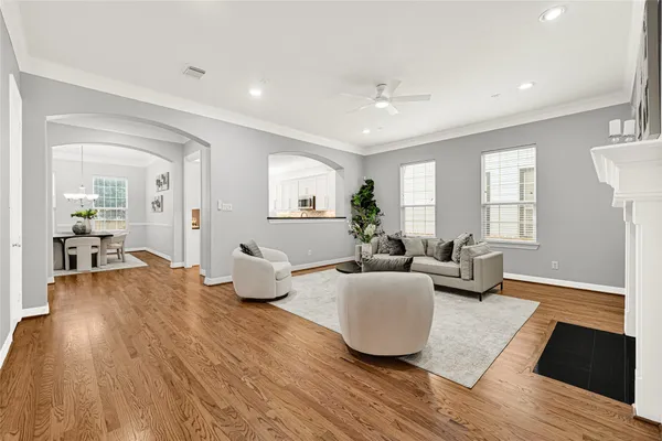 a living room with furniture and wooden floor
