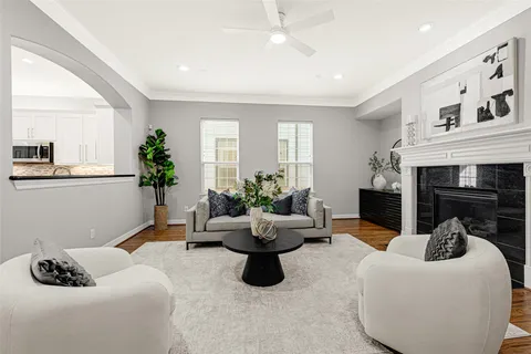 a kitchen with stainless steel appliances granite countertop a stove a sink dishwasher a refrigerator and white countertops with wooden floor