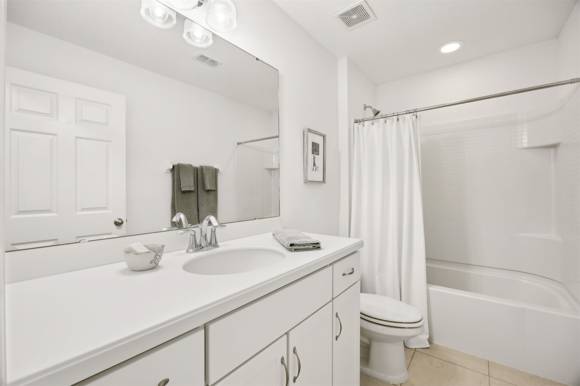 94037 Last Lane Yulee, FL 32097 - Photo 26 of 38 a bathroom with a sink a toilet a mirror a vanity and shower