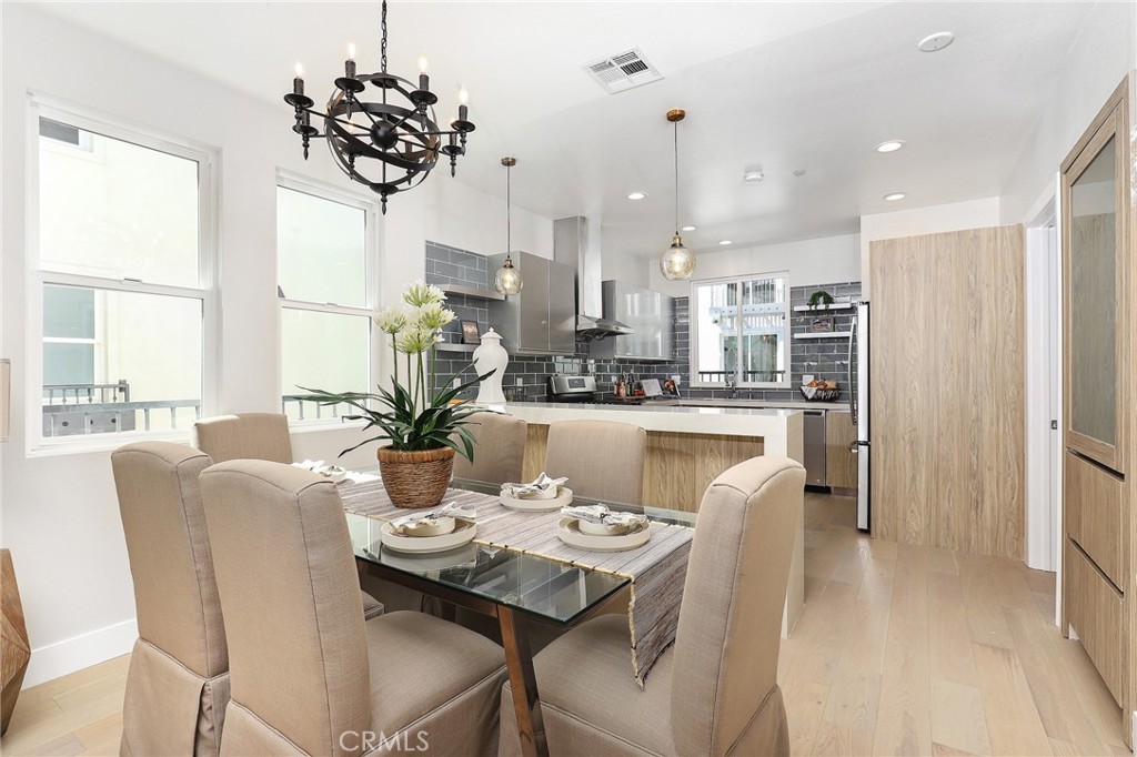 15 Turnberry Lane Phillips Ranch, CA 91766 - Photo 34 of 63 a dining room with furniture a chandelier and wooden floor