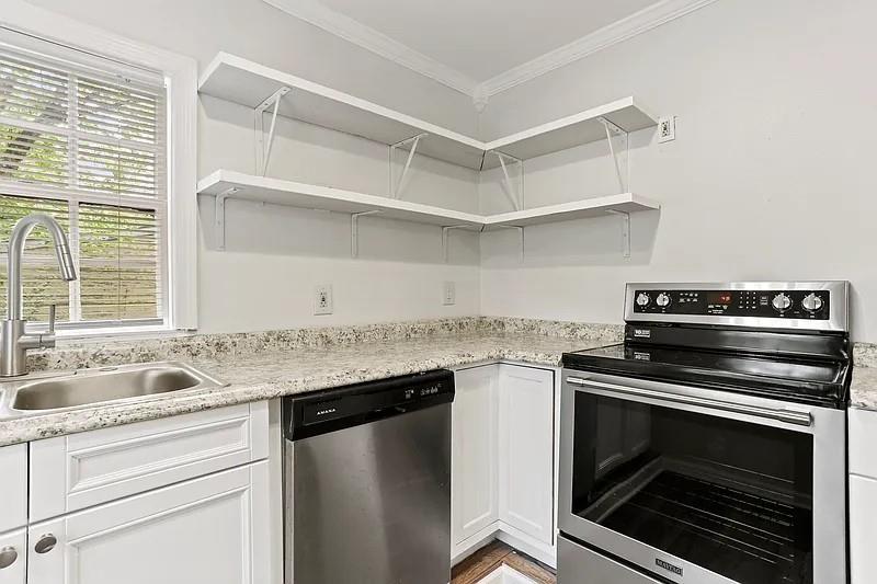 1268 Eastland Road Southeast, Unit B Atlanta, GA 30316 - Photo 11 of 20 a kitchen with granite countertop a stove and a sink