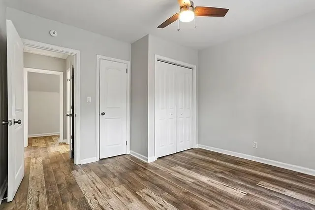 a view of empty room with wooden floor
