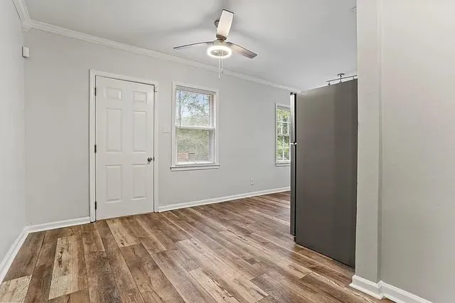 wooden floor in an empty room with a window
