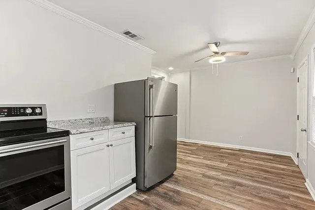 a kitchen with a stove refrigerator and microwave