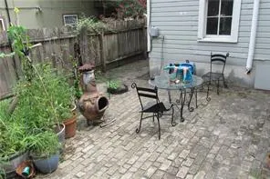 a view of a chairs and table in backyard