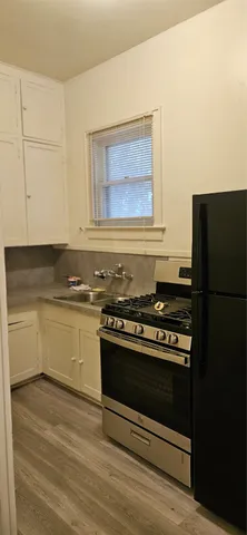 a kitchen with a stove and a refrigerator