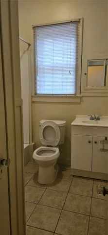 a bathroom with a toilet a sink and a window