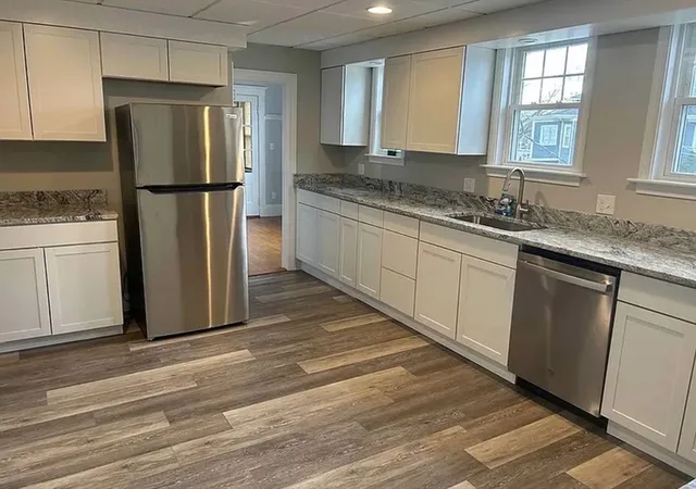 a kitchen with a refrigerator and a sink