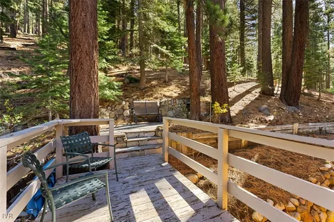 a view of balcony with wooden floor and fence