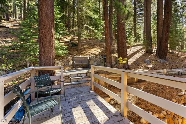 a view of balcony with wooden floor and fence