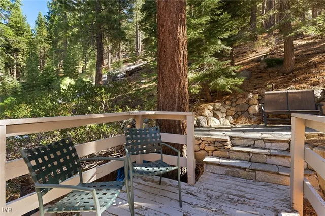 a view of balcony with wooden floor and outdoor seating
