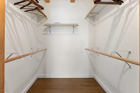 a view of walk in closet with empty racks