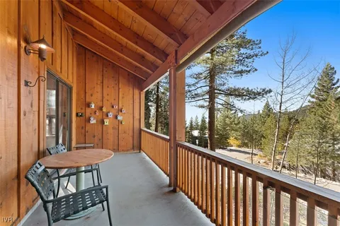 a balcony with table and chairs