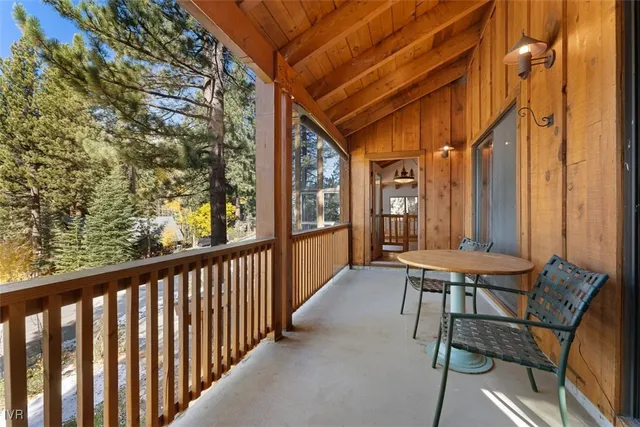 a balcony with chairs and table