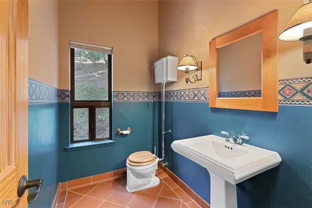 a bathroom with a sink a toilet and mirror
