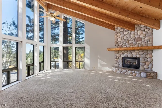 a view of an empty room with a fireplace and a window