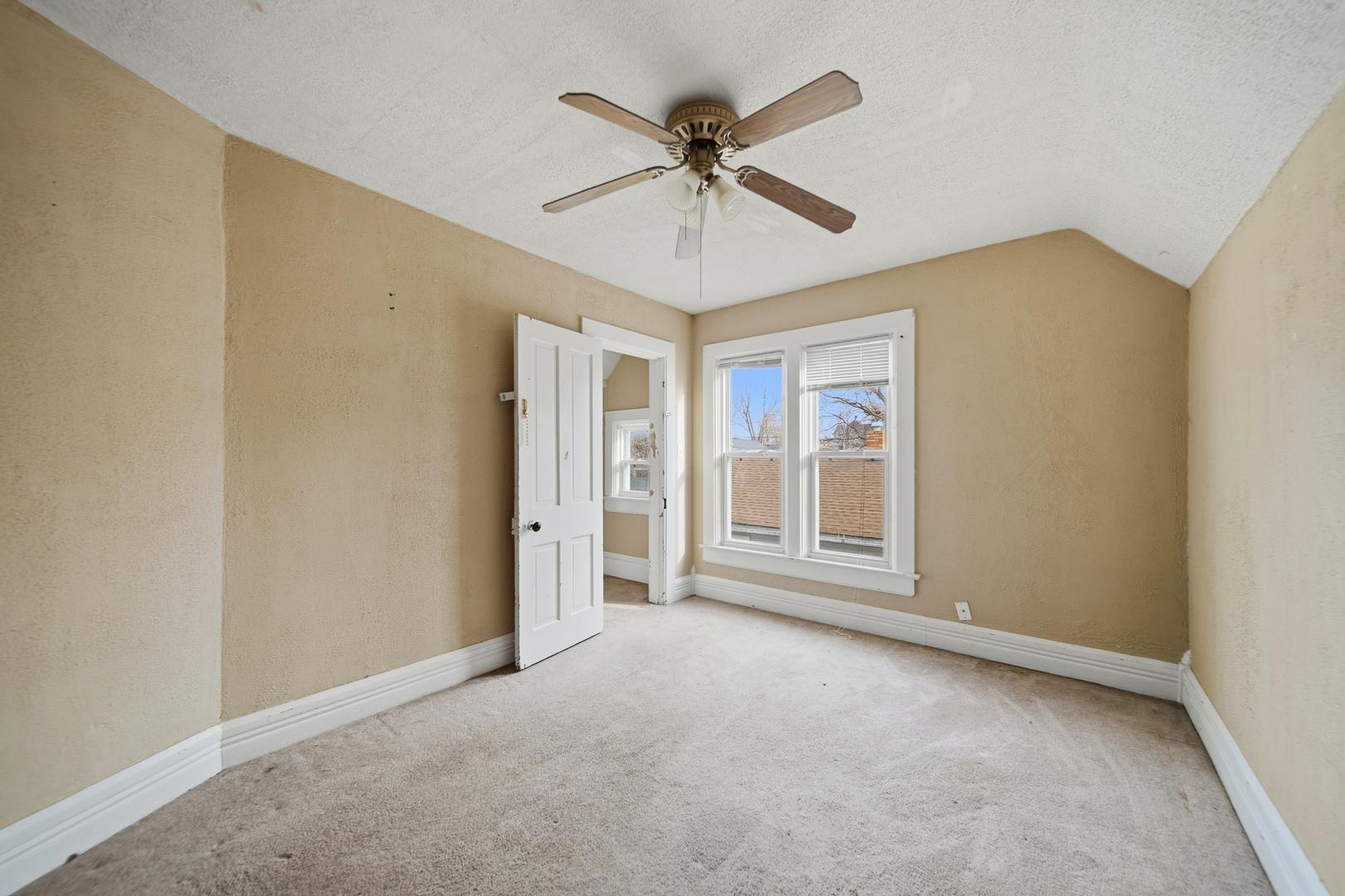 119 Douglas Avenue Dixon, IL 61021 - Photo 8 of 17 an empty room with chandelier fan and windows