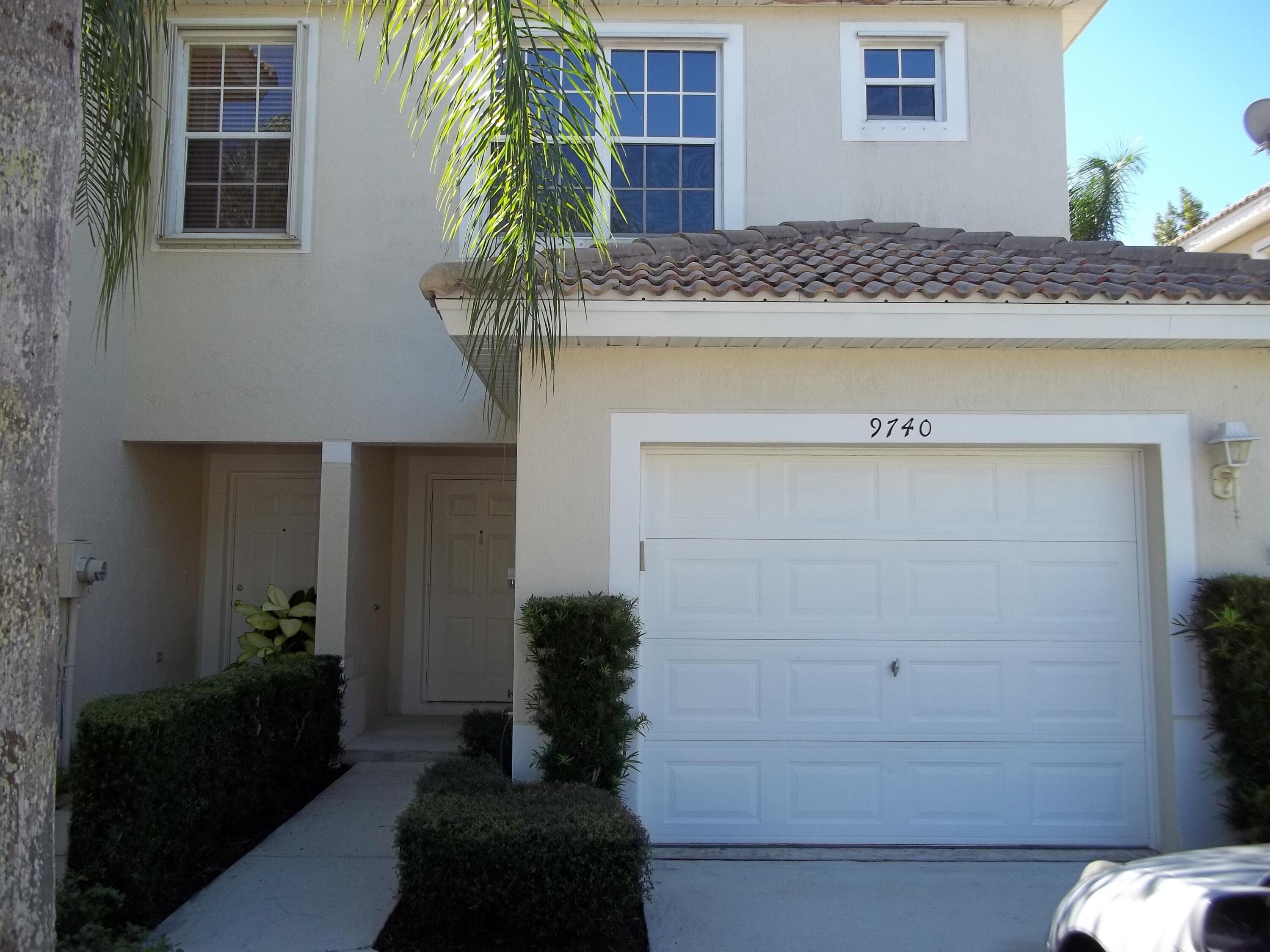 a view of front door and potted plants