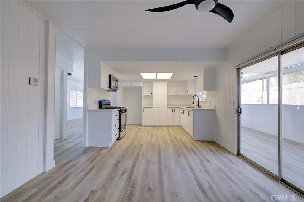 3700 Buchanan Street, Unit 164 Riverside, CA 92503 - Photo 20 of 40 a view of kitchen and empty room with wooden floor