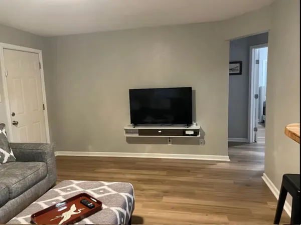 a living room with a flat screen tv a couch and a coffee table