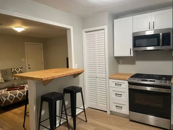 a kitchen with a stove and a microwave