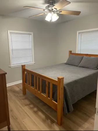 a bedroom with a bed and a chandelier