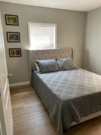 a bedroom with a bed and a window