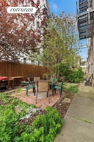 a living room with couch dining table and a large window