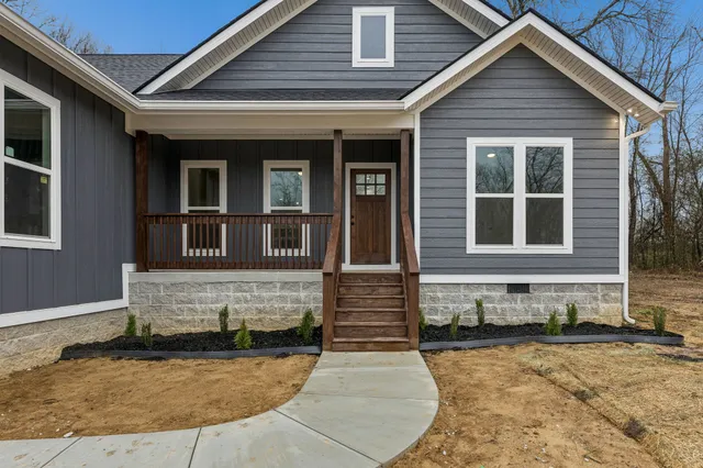 a front view of a house with large windows