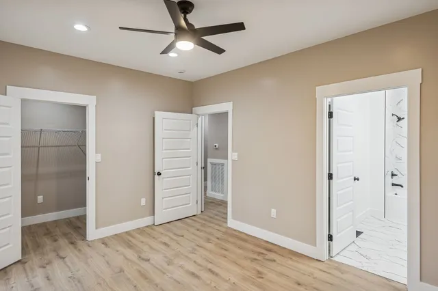 wooden floor in an empty room with a bathroom