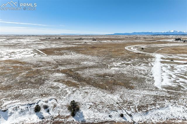 15770 Atlas Loop Peyton, CO 80831 - Photo 8 of 10 Snowy aerial view with a mountain view