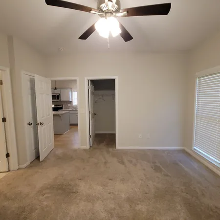 a view of a kitchen with a sink and a ceiling fan