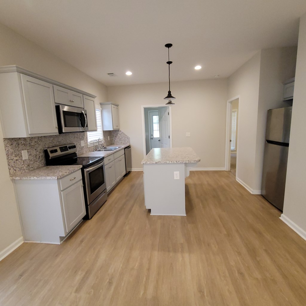 3604 4th Avenue Columbus, GA 31904 - Photo 5 of 19 a large kitchen with cabinets wooden floor and stainless steel appliances