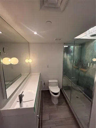 a bathroom with a toilet and a shower